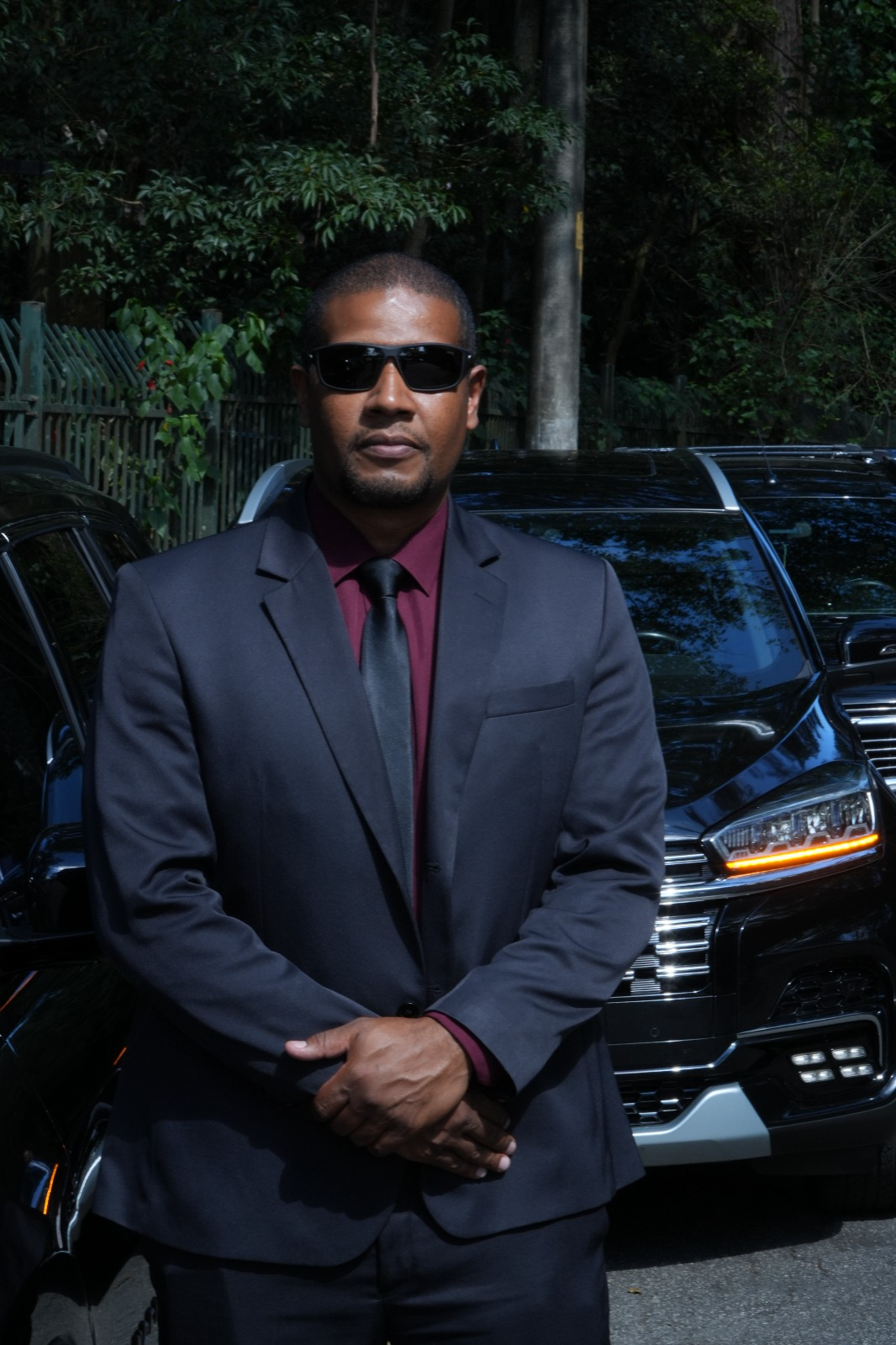 Transfersafe executive chauffeur next to vehicle, ready for trips departing São Paulo to anywhere in Brazil