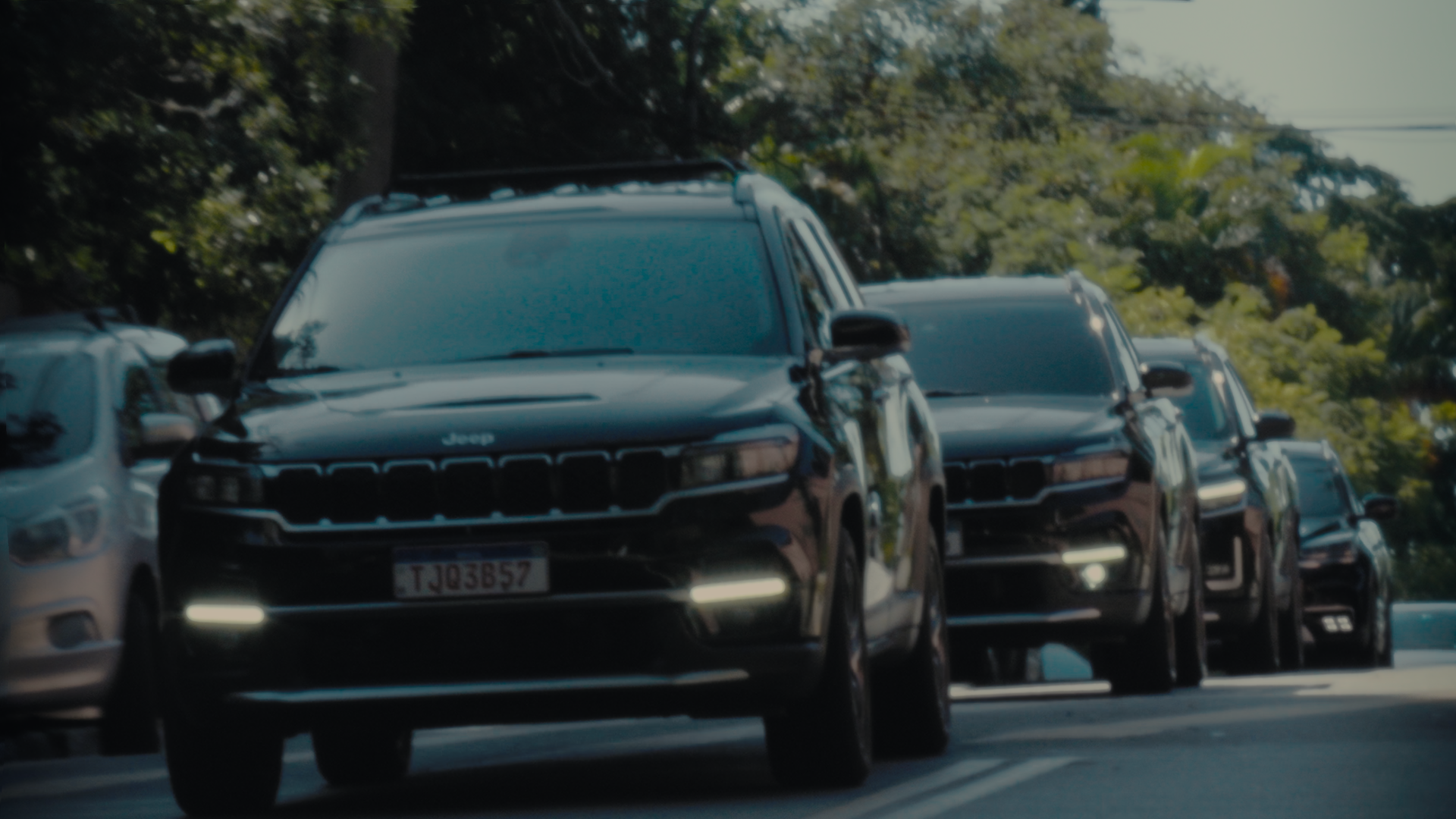 Executive entering black sedan with chauffeur holding the door